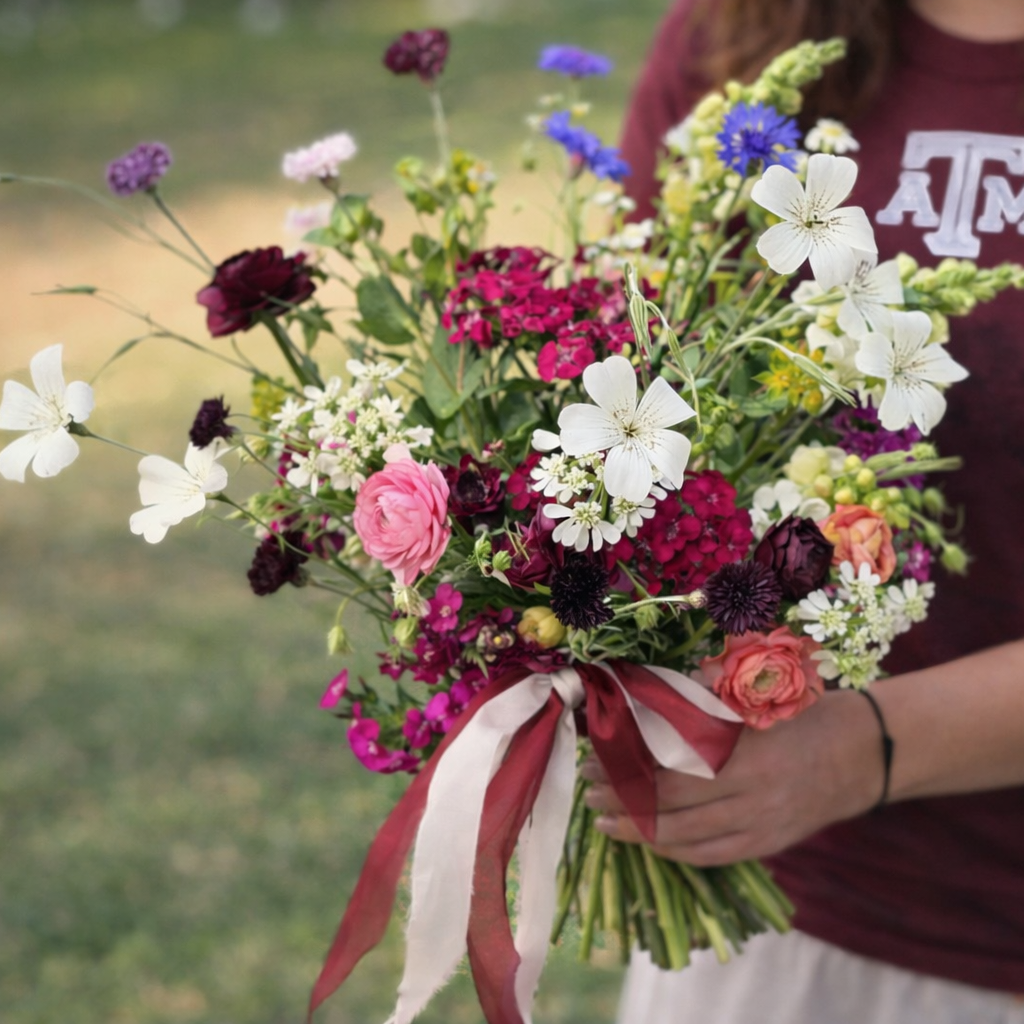 Seasonal garden-style bouquet in maroon and white gathered for an Aggie celebration by Bella Vista Flower Farm.