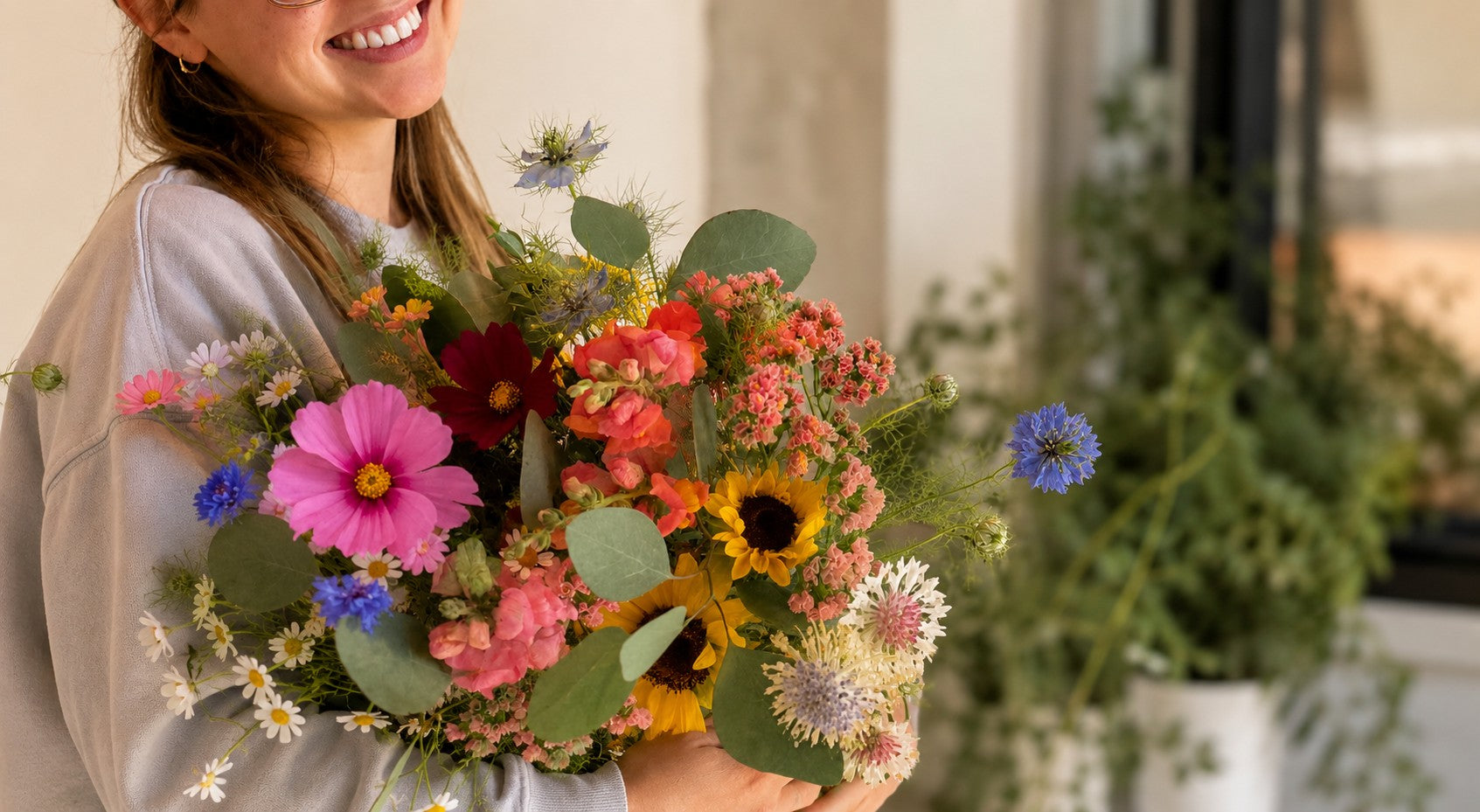 Customer carrying a seasonal, garden-style bouquet from Bella Vista Flower Farm after picking up Everyday Flowers.