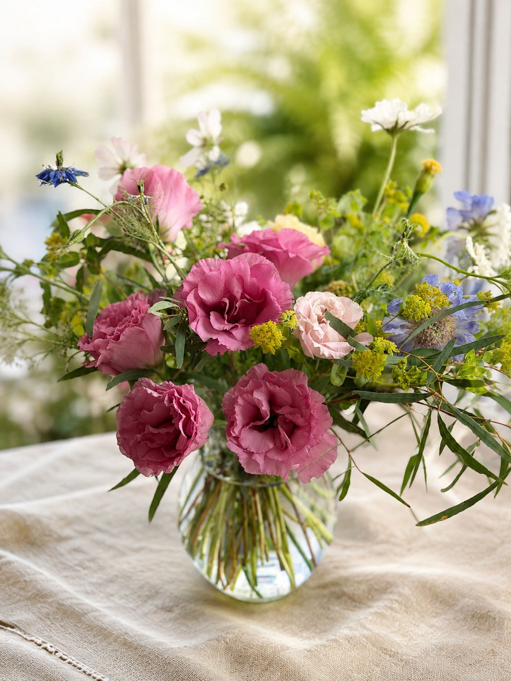 Loose Texas-grown flower stems arranged naturally in small vases for a bridal shower table
