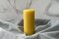 Close-up of a pure beeswax pillar candle showing natural texture