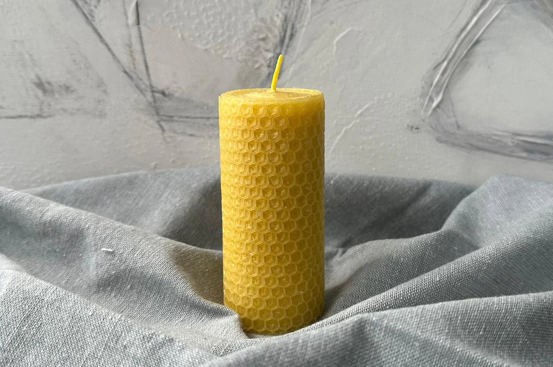 Close-up of a pure beeswax pillar candle showing natural texture