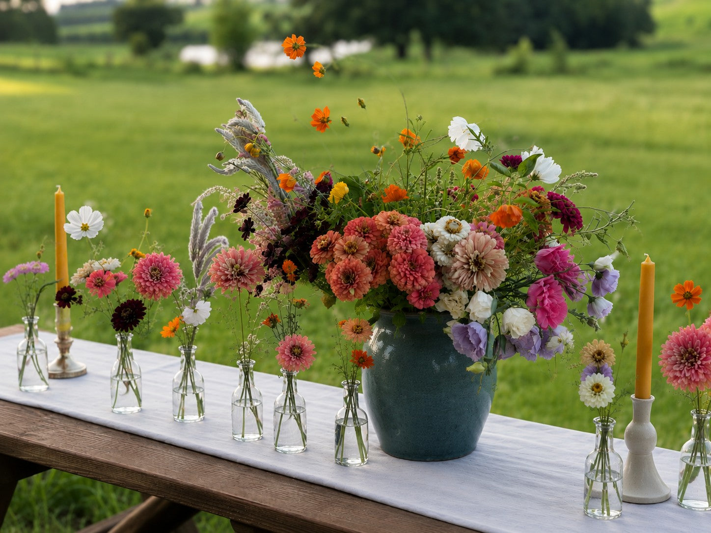 Garden-style summer table decorated with seasonal farm-grown flowers arranged from a Bella Vista Hosting Flowers bucket.